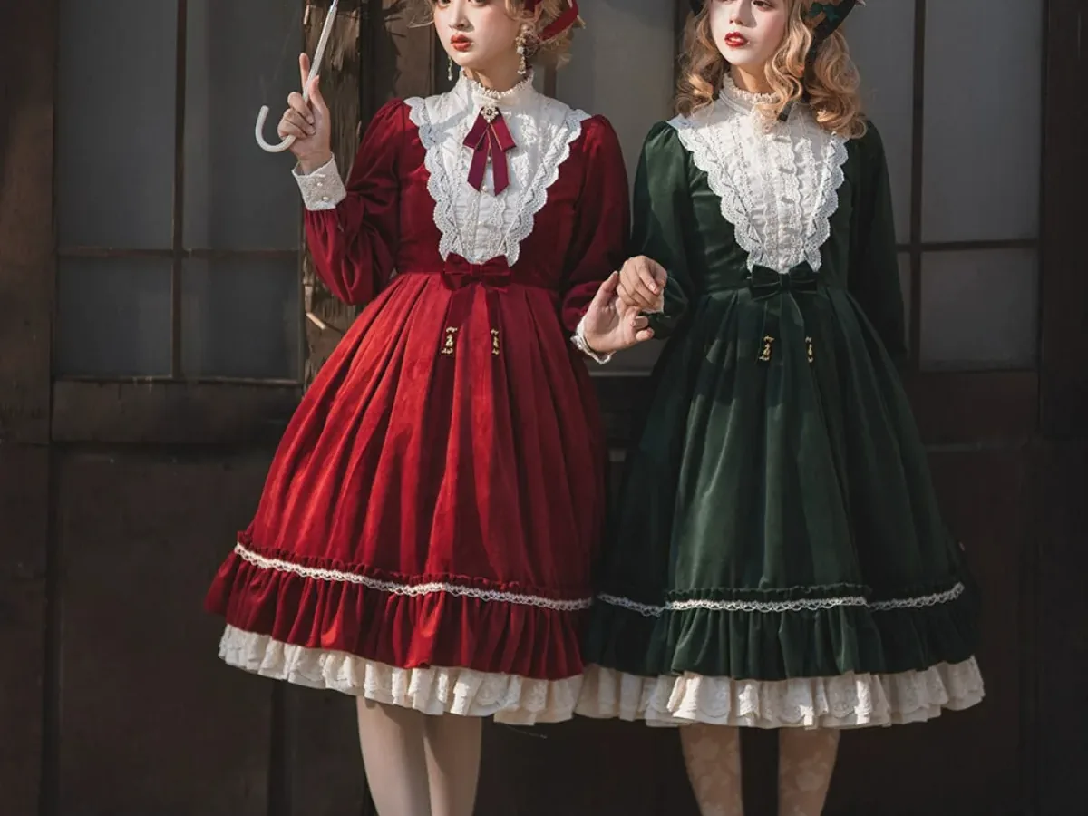Wine and forest-green velvet dresses in an elegant outdoor setting